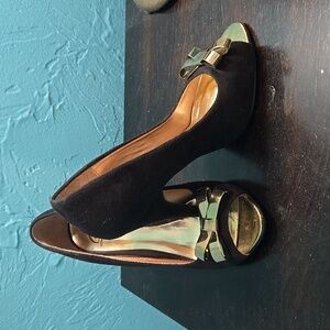 Black peep-toe heels with gold bow